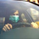 COVID-19 pandemic and the Rise in Car Crash Deaths What Happened - image showing driver wearing mask during covid 19